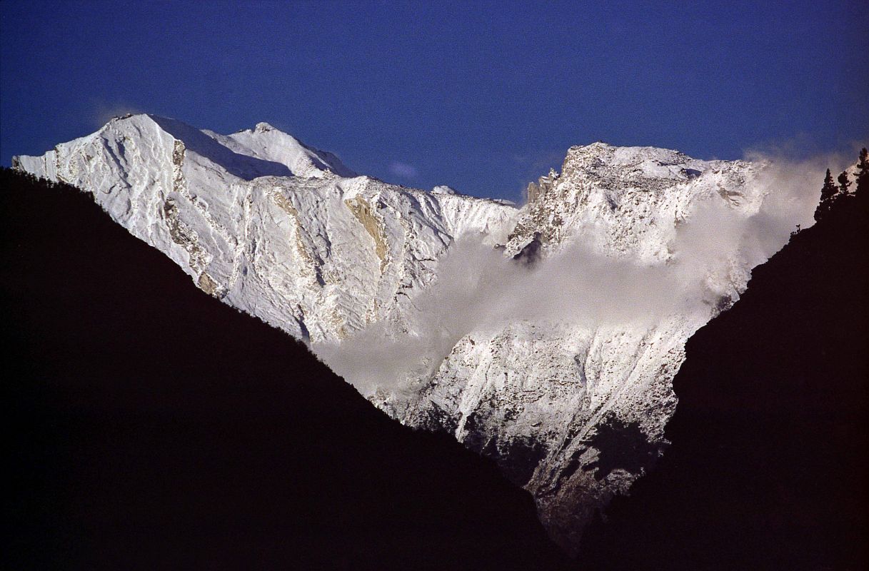201 End Of Dhaulagiri Ridge From After Marpha I got up in Marpha at 5:30 to a cloudless sky, and after a breakfast Coke, Fanta and Snickers, I was on the trail to Lete at 6:30. I could see the end of the Dhaulagiri Ridge directly ahead in the early morning sun.